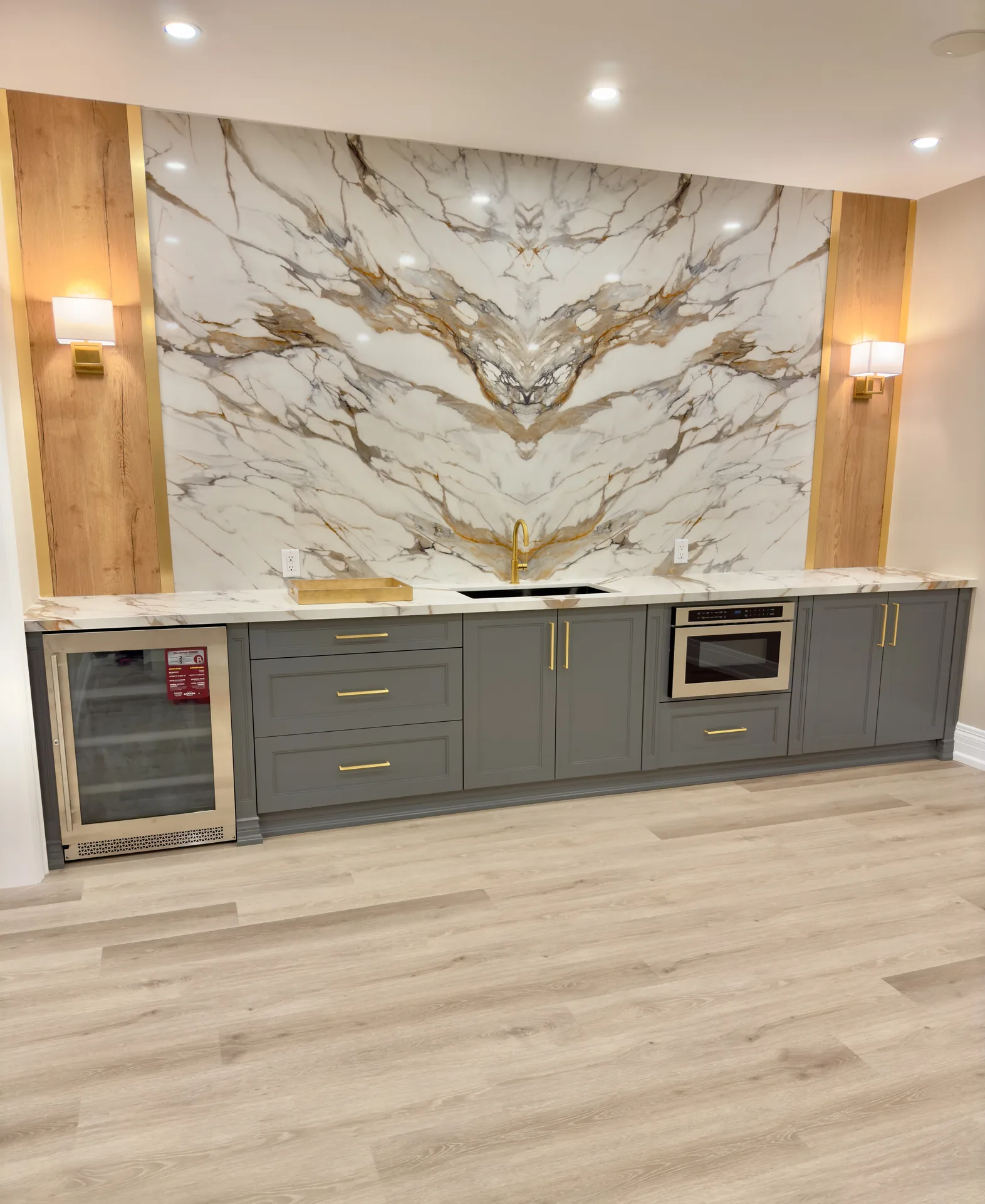 Home renovations in Etobicoke — basement bar with gold-veined marble backsplash and wood accents