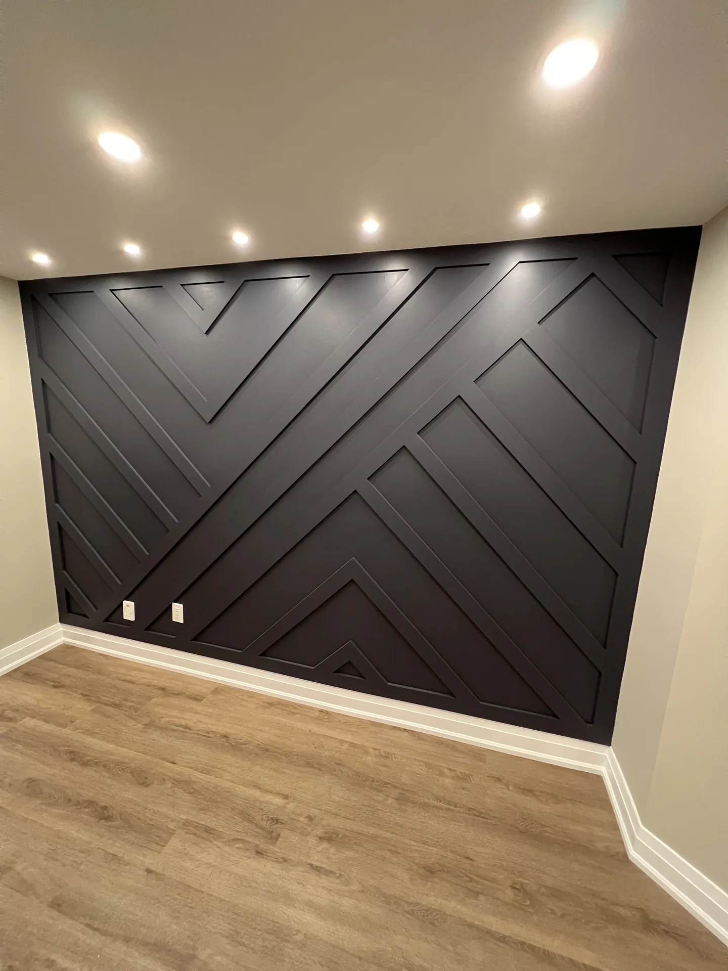 Structural work in Vaughan — charcoal chevron feature wall in a finished basement
