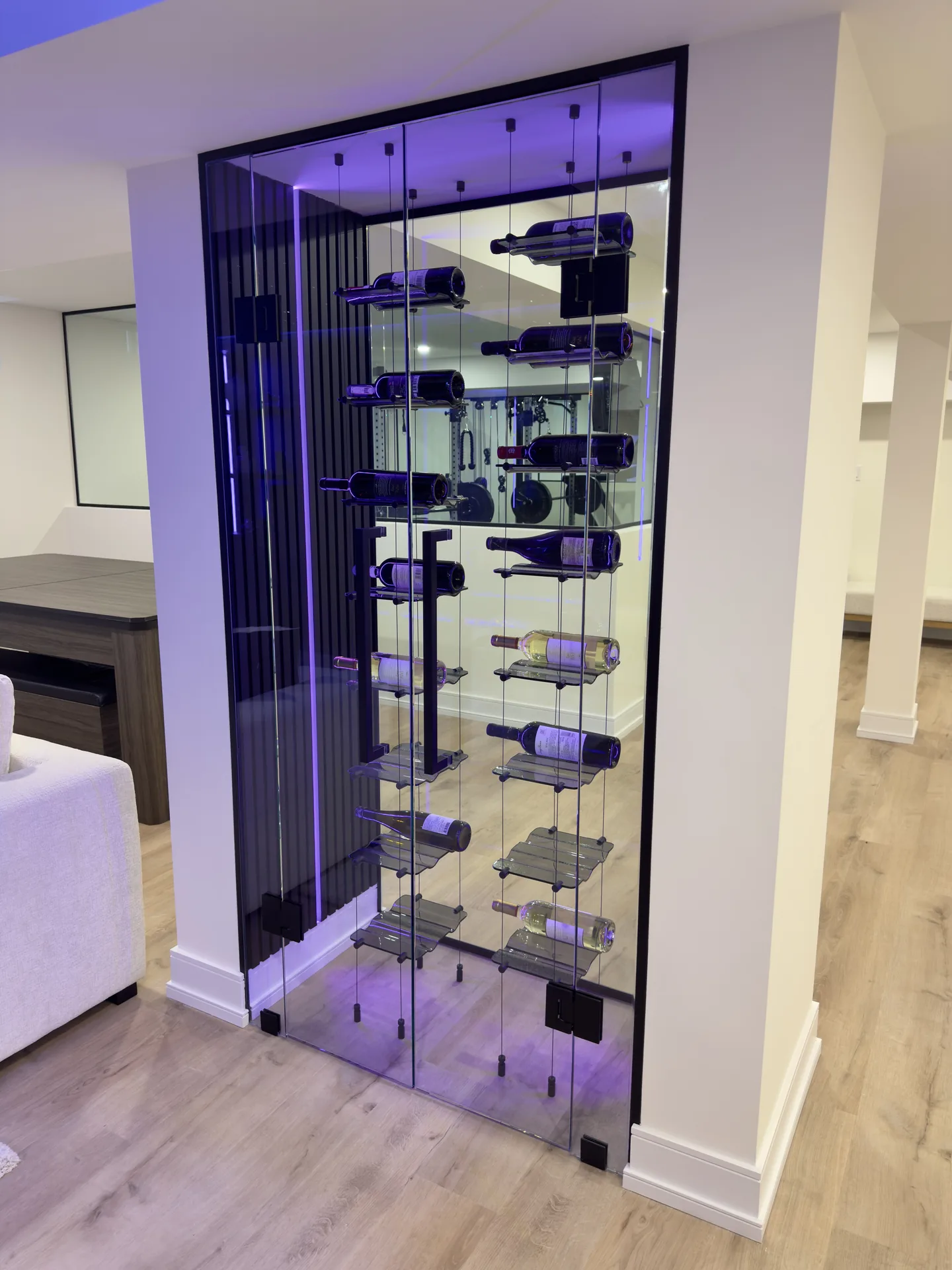 Home renovations in Newmarket — glass-enclosed wine closet with LED display in a finished basement