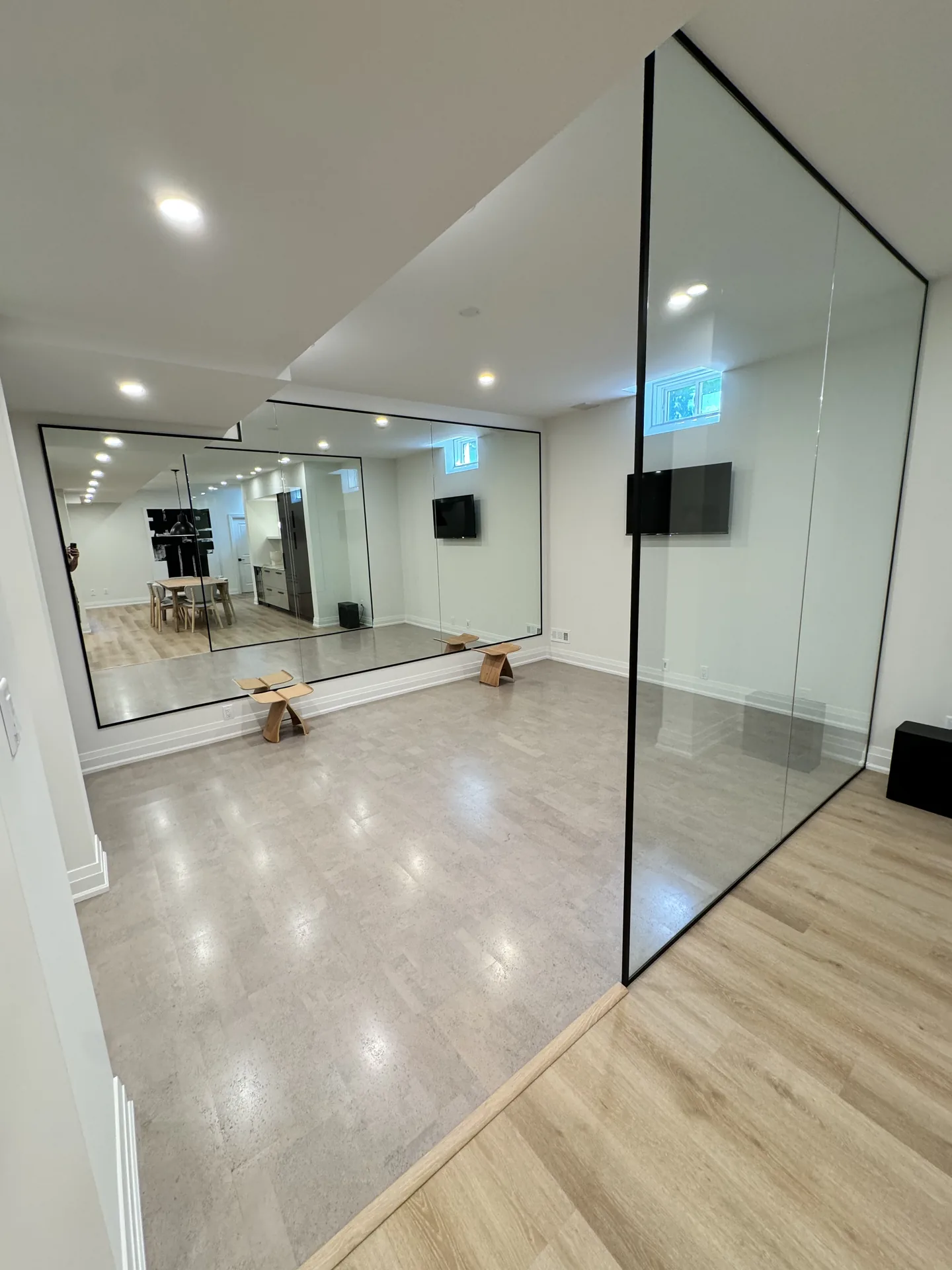 Structural work in Markham — basement gym with glass partition and mirror walls