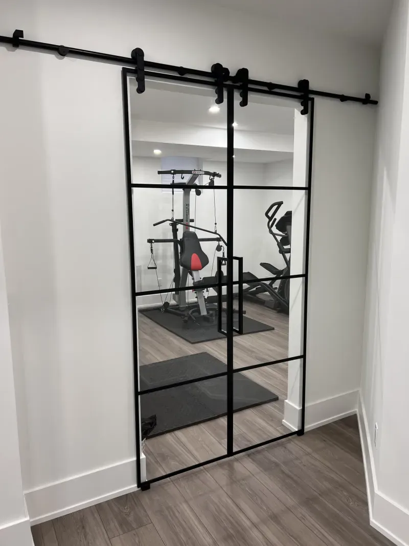 basement gym black frame glass barn door