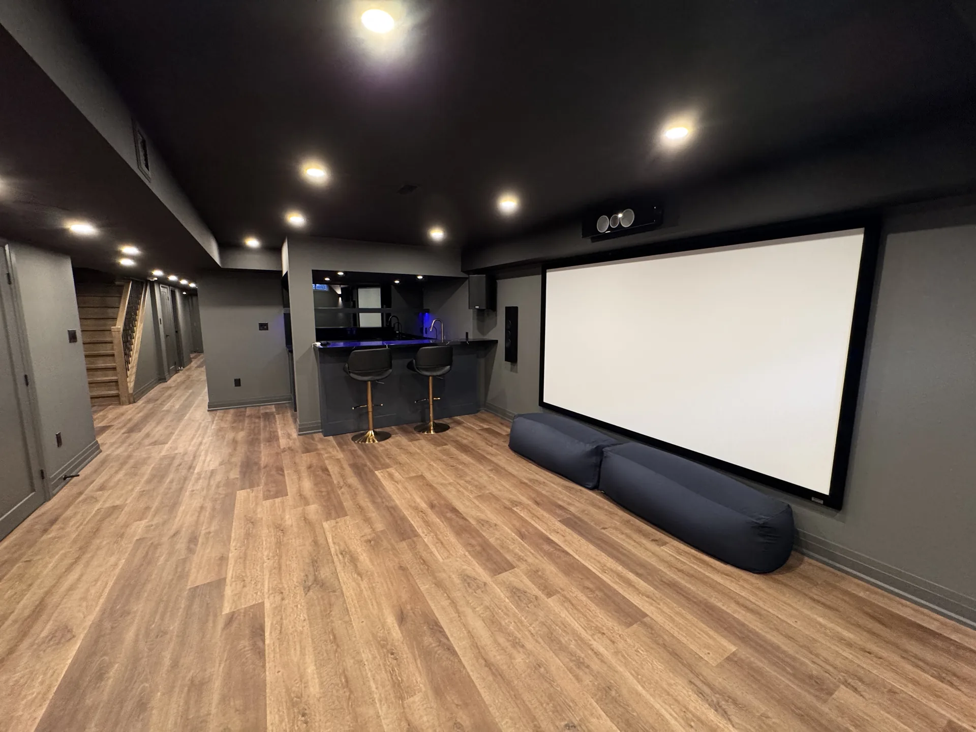Basement finishing in Vaughan — basement home theatre with projector screen and bar