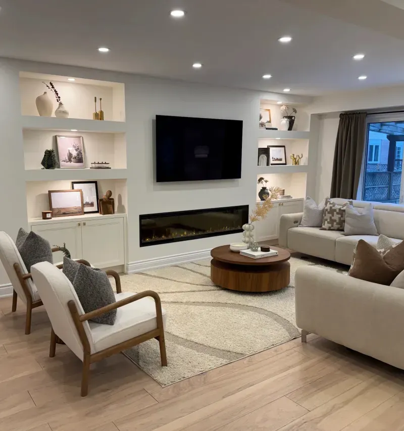 basement media wall armchairs fireplace