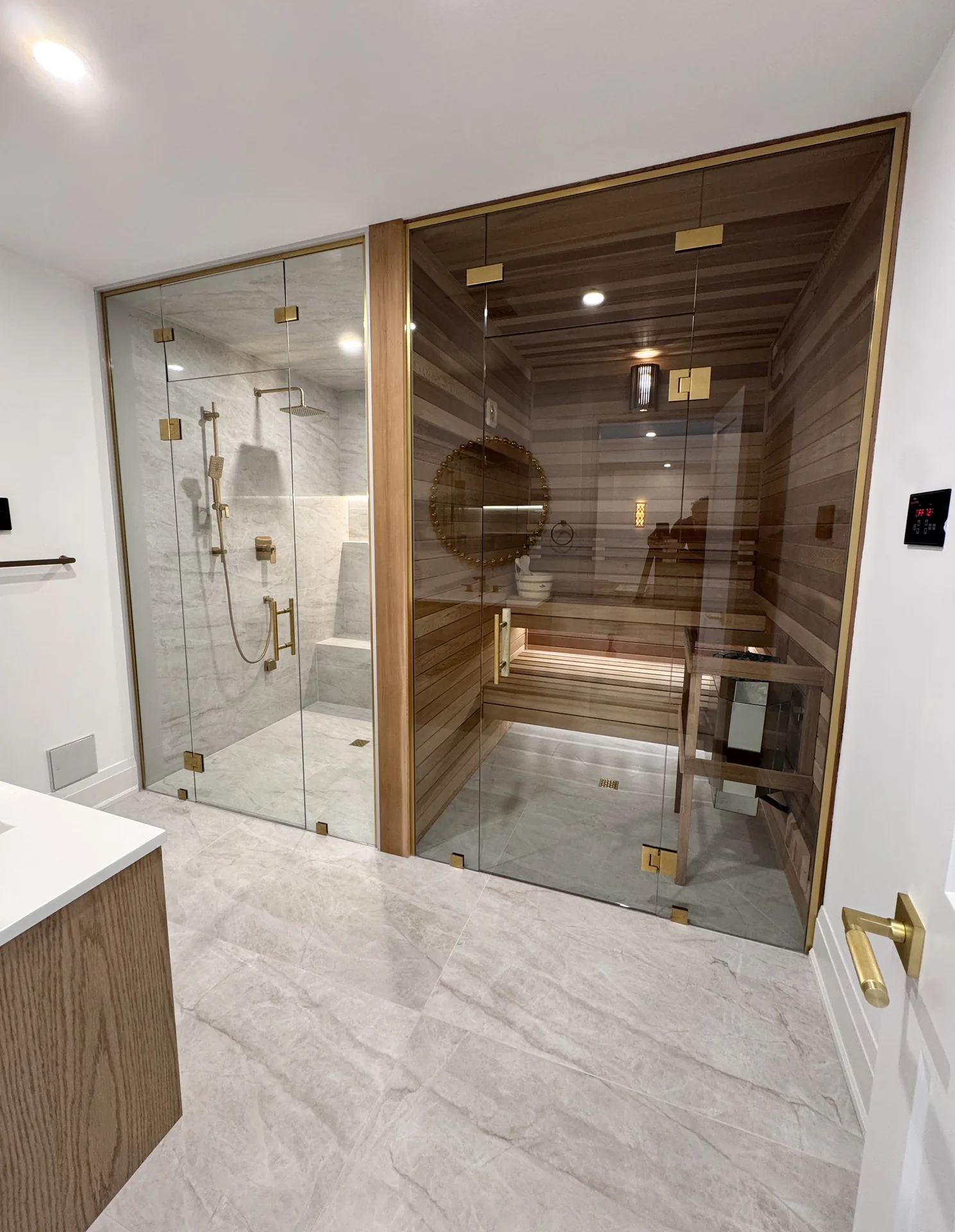 Structural work in Burlington — basement spa bathroom with glass shower and cedar sauna