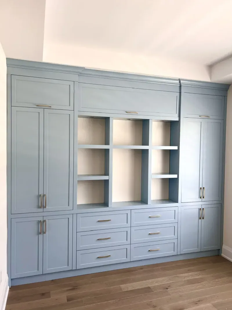 basement office blue builtin cabinetry