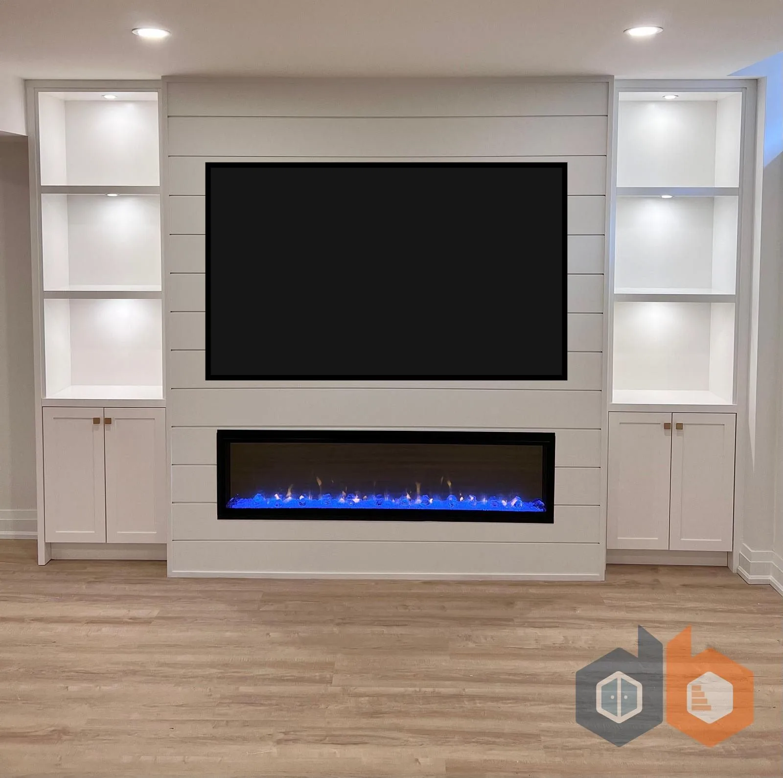 Basement finishing in Innisfil — shiplap basement media wall with blue-flame linear fireplace