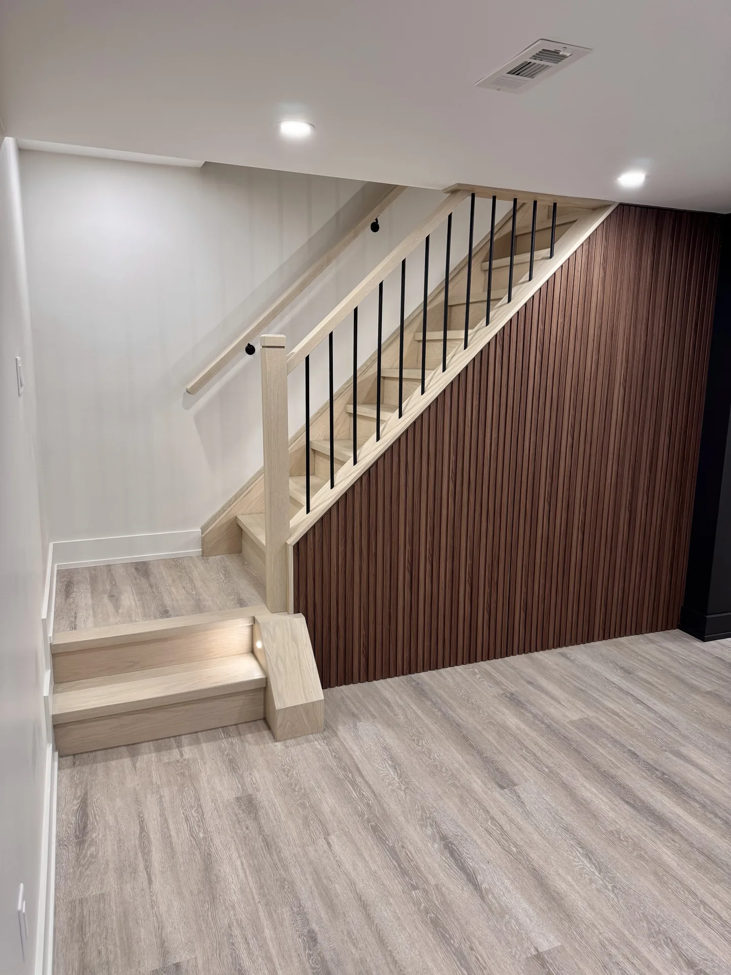 Structural work in Whitby — basement staircase with walnut slat feature wall