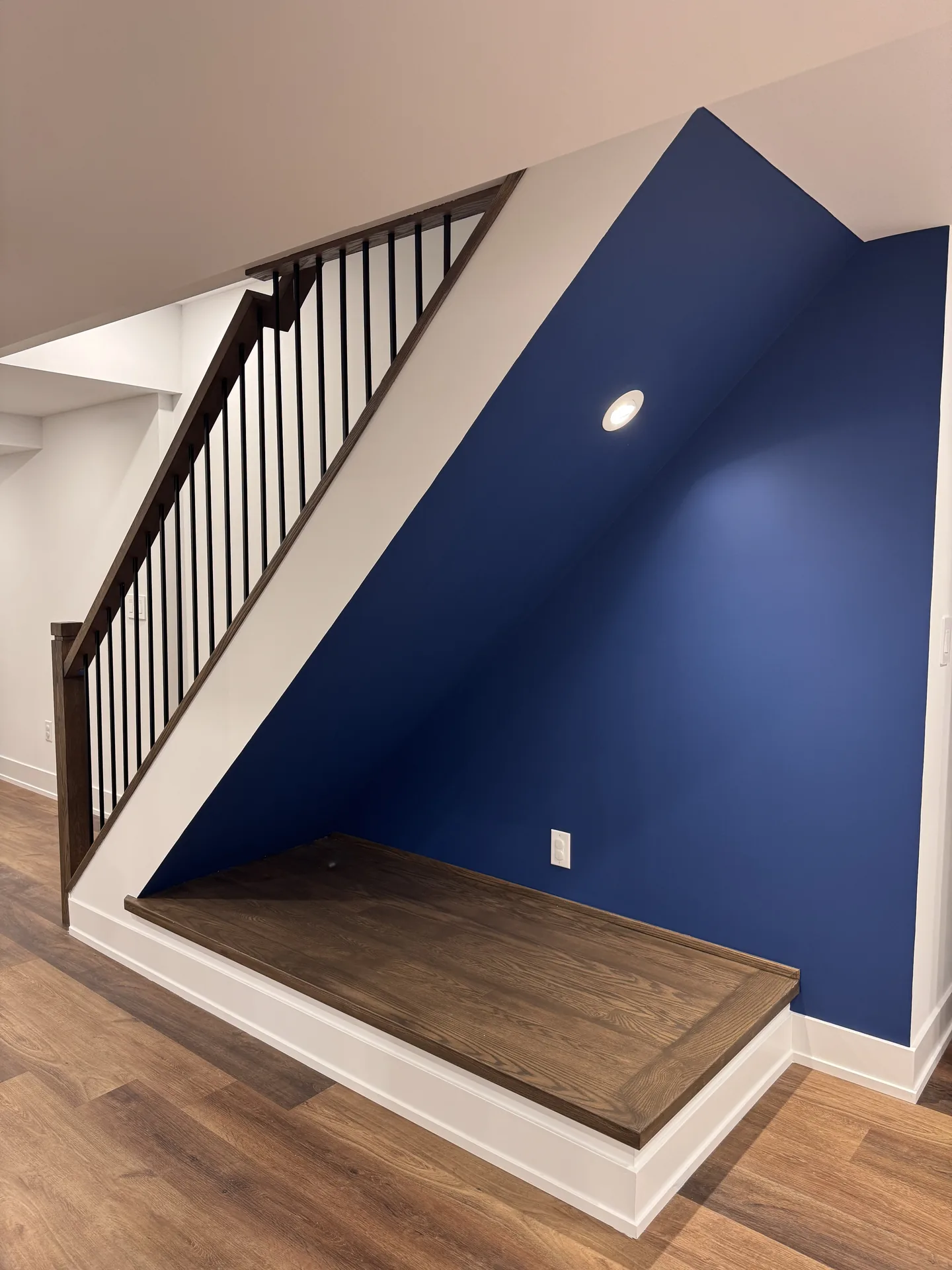 Structural work in Pickering — basement staircase with navy accent wall and oak treads