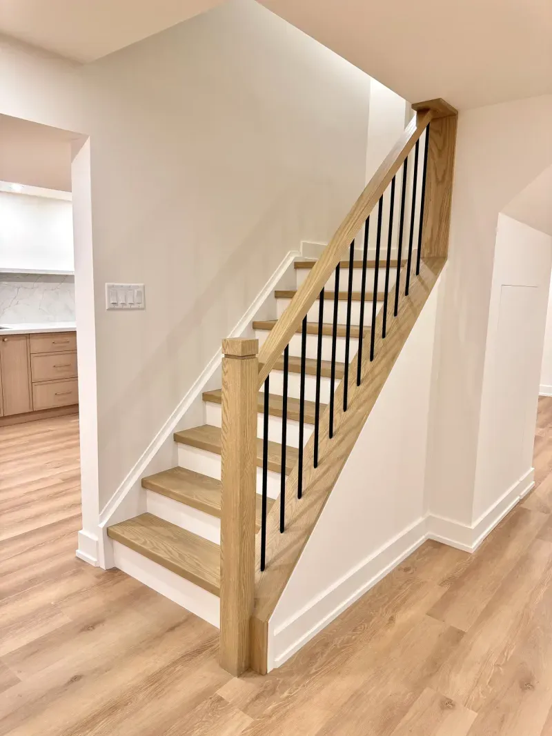 basement staircase white oak black spindles