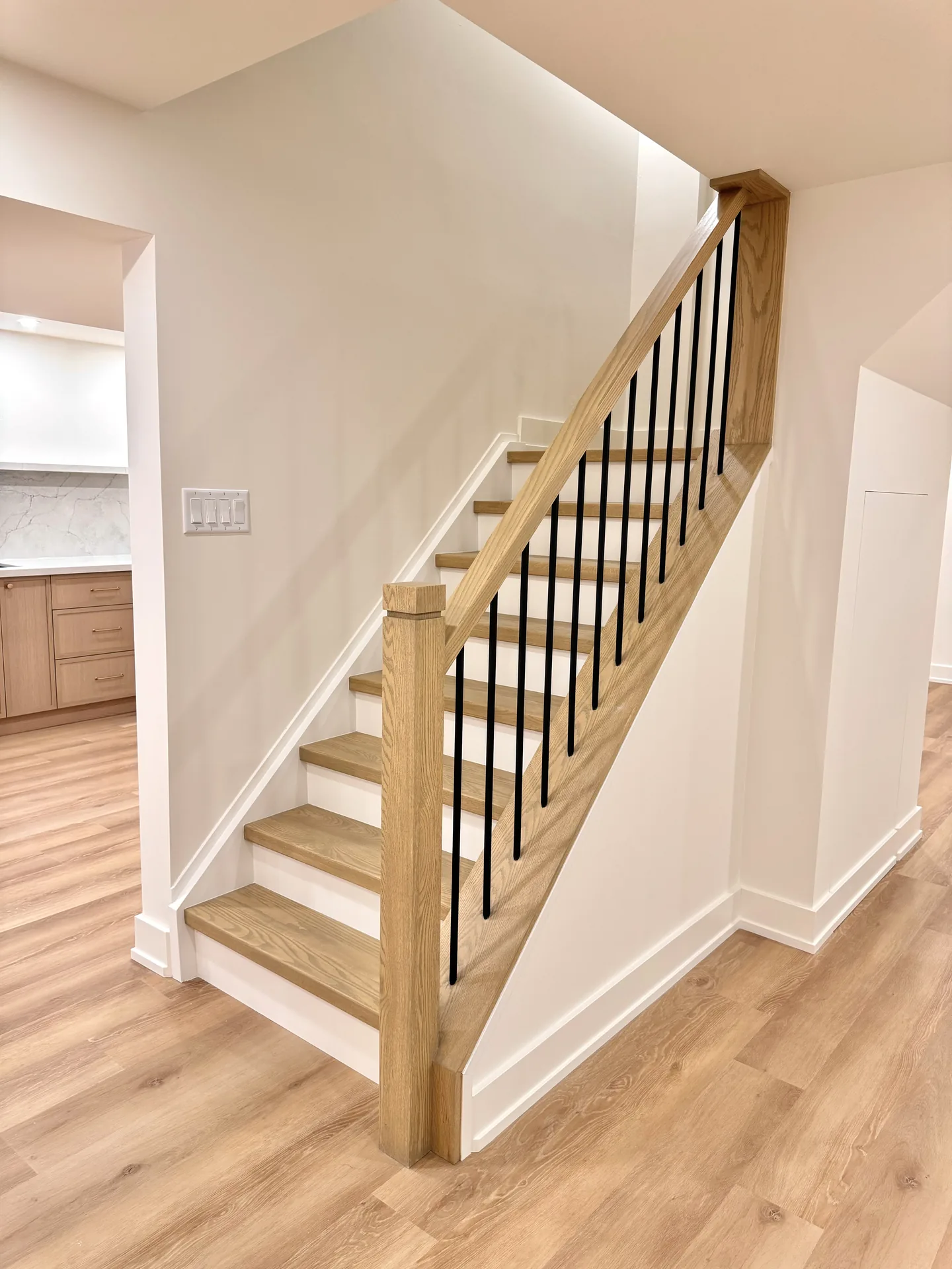 Structural work in Oshawa — white oak basement staircase with black spindles