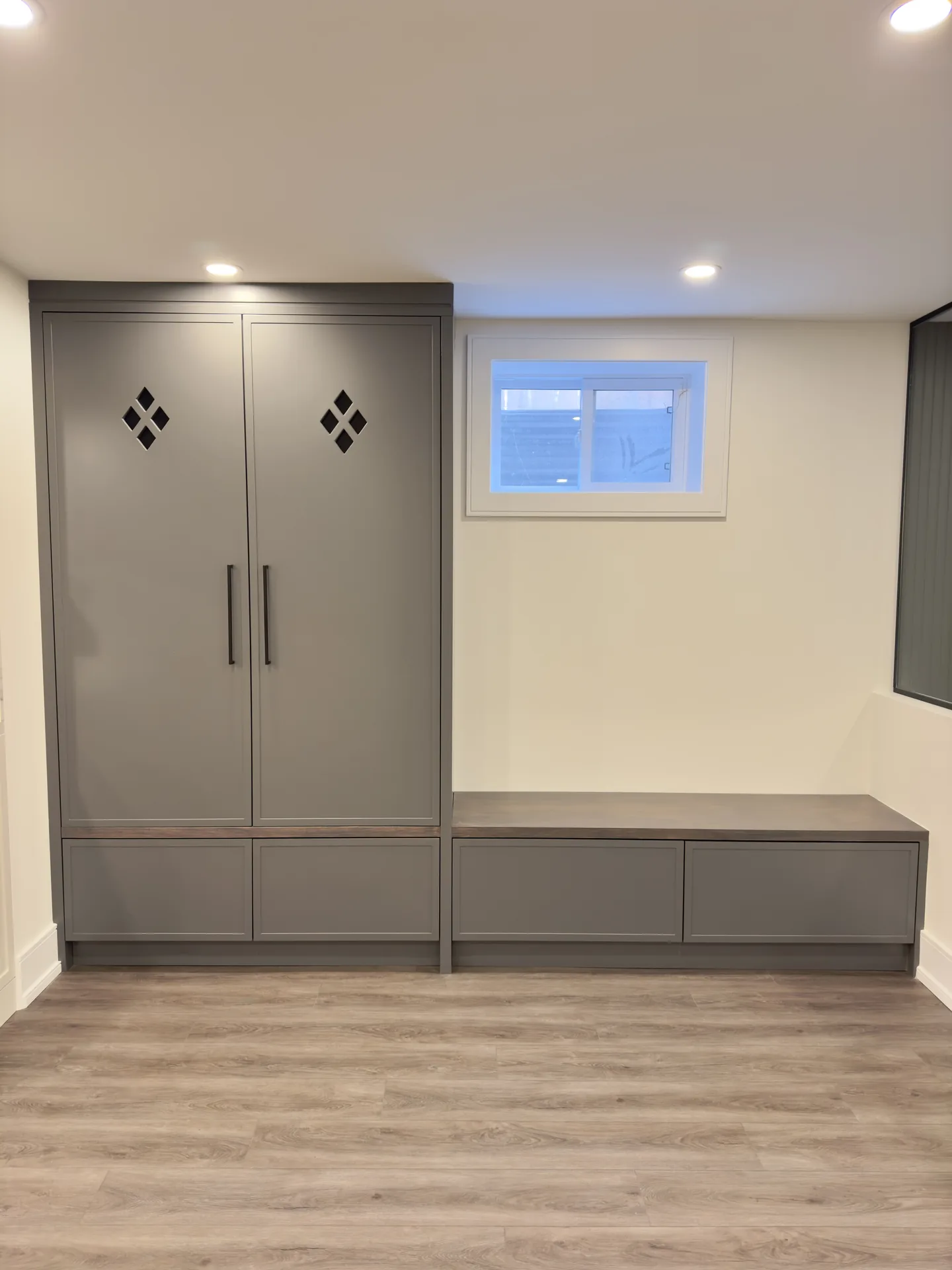 Home renovations in Ajax — grey custom storage and seating unit in a finished basement