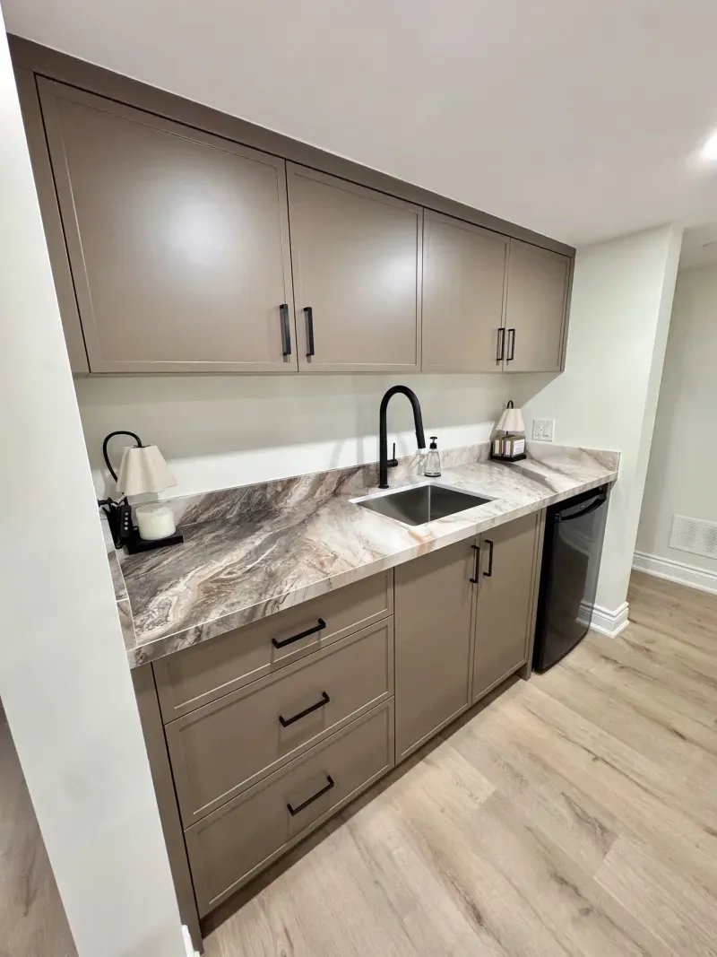 basement wet bar taupe cabinets stone counter