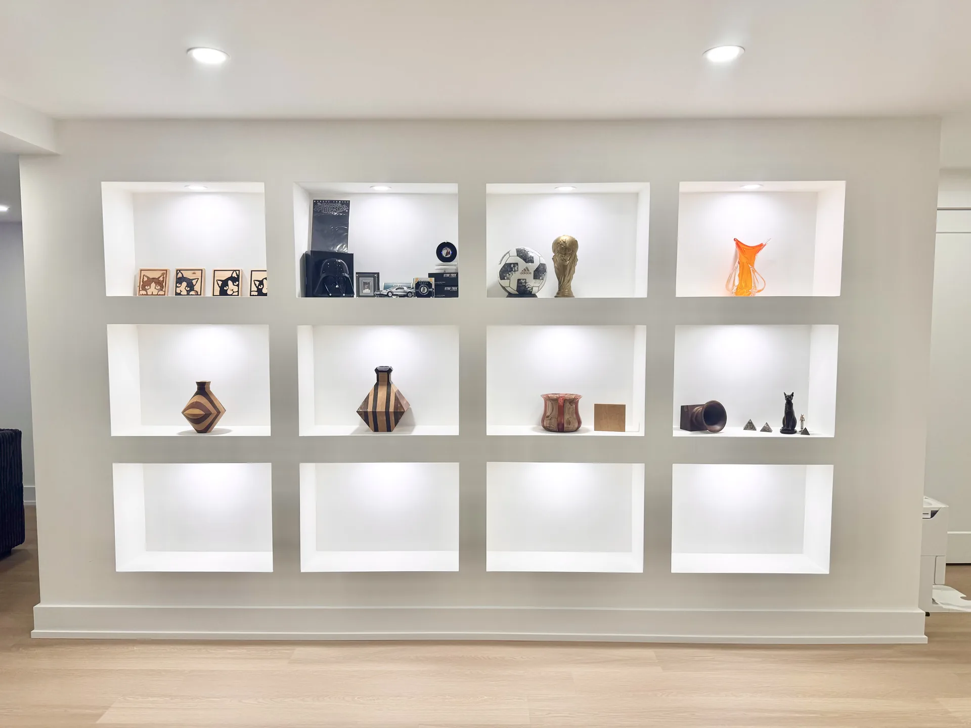 White display wall with LED-lit niches — basement renovation in King City by Desire Basements