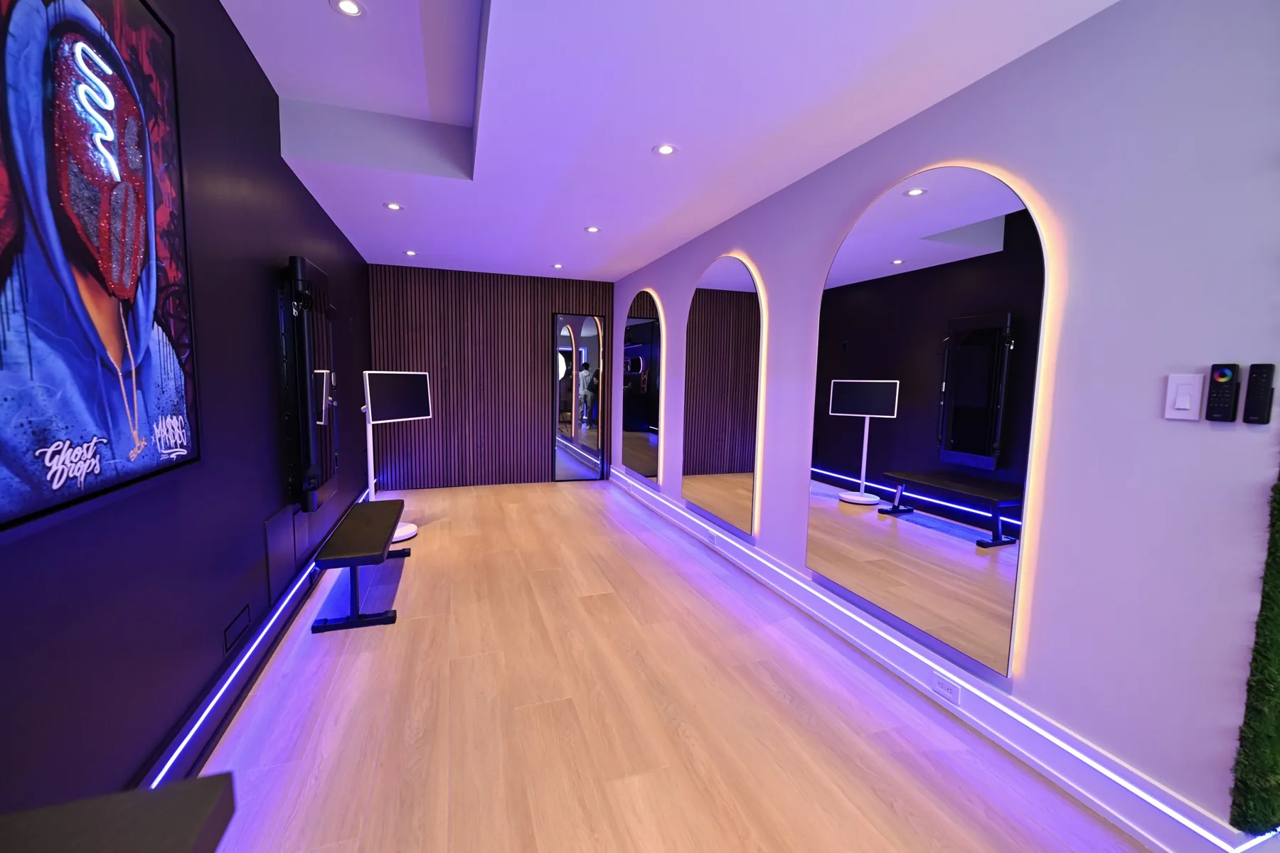 Hallway with wood-slat walls and arched openings