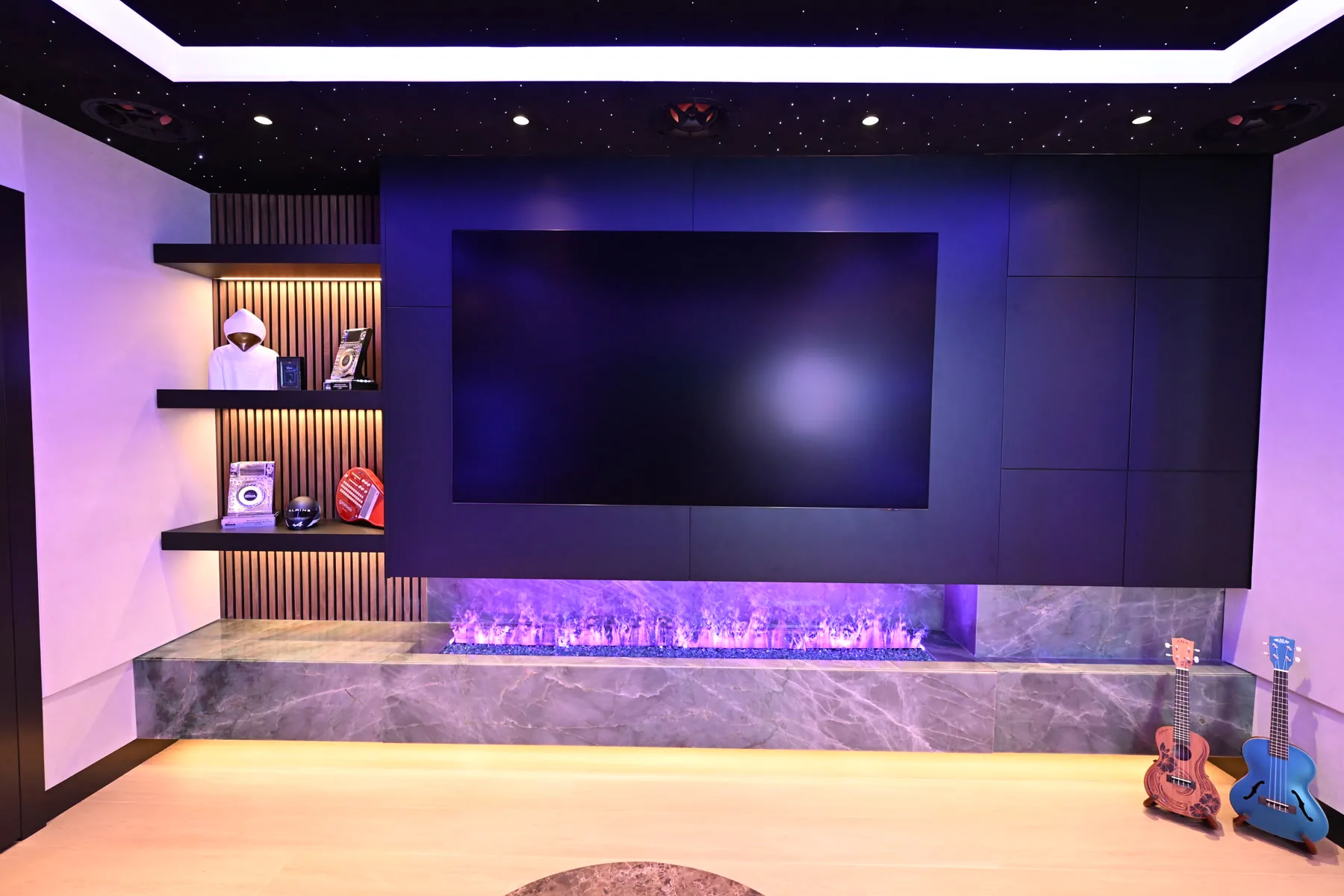 Lounge media wall, linear fireplace and lit shelves at Sickick Studio