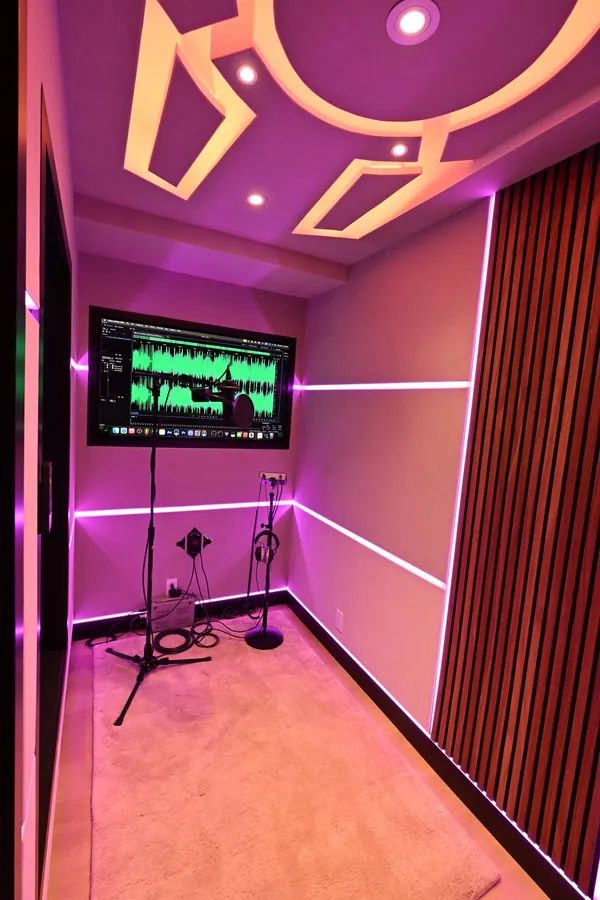 Inside the vocal booth at Sickick Studio, LED-lined walls and a lit ceiling panel