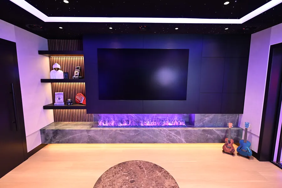 Star-ceiling lounge with media wall and linear fireplace at Sickick Studio