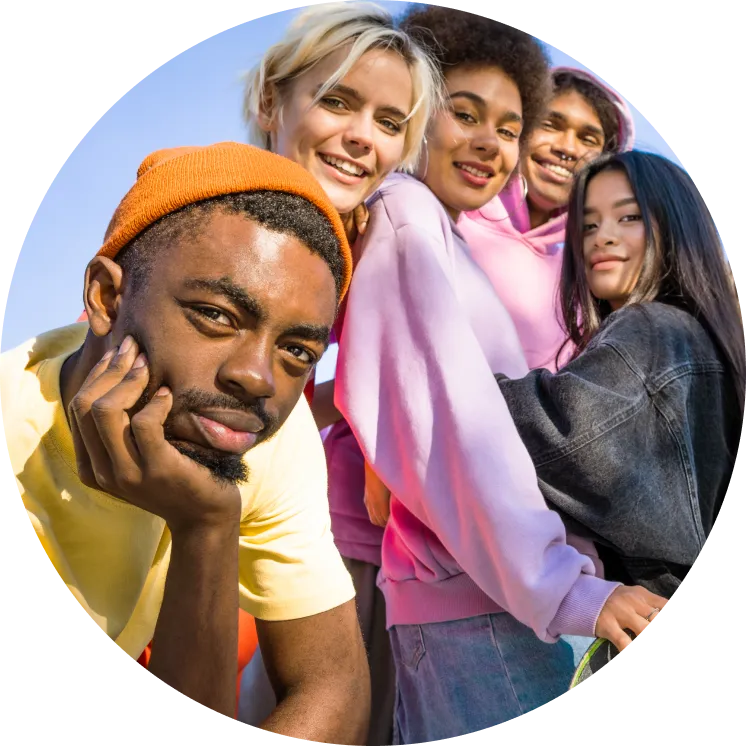 five young adults posing in front of the sky in colourful outfits, cropped in  a circle