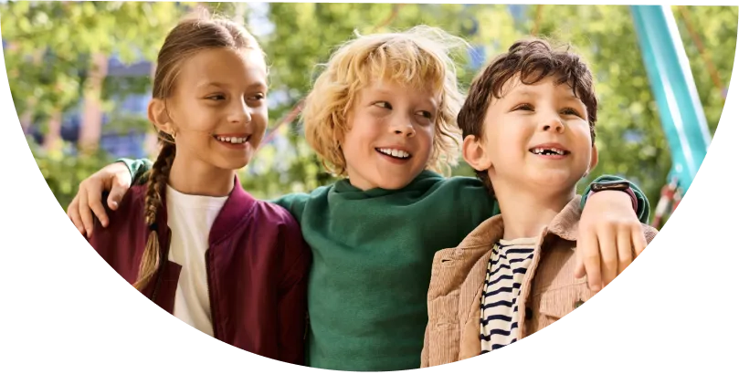Three happy children in nature cropped in a half circle