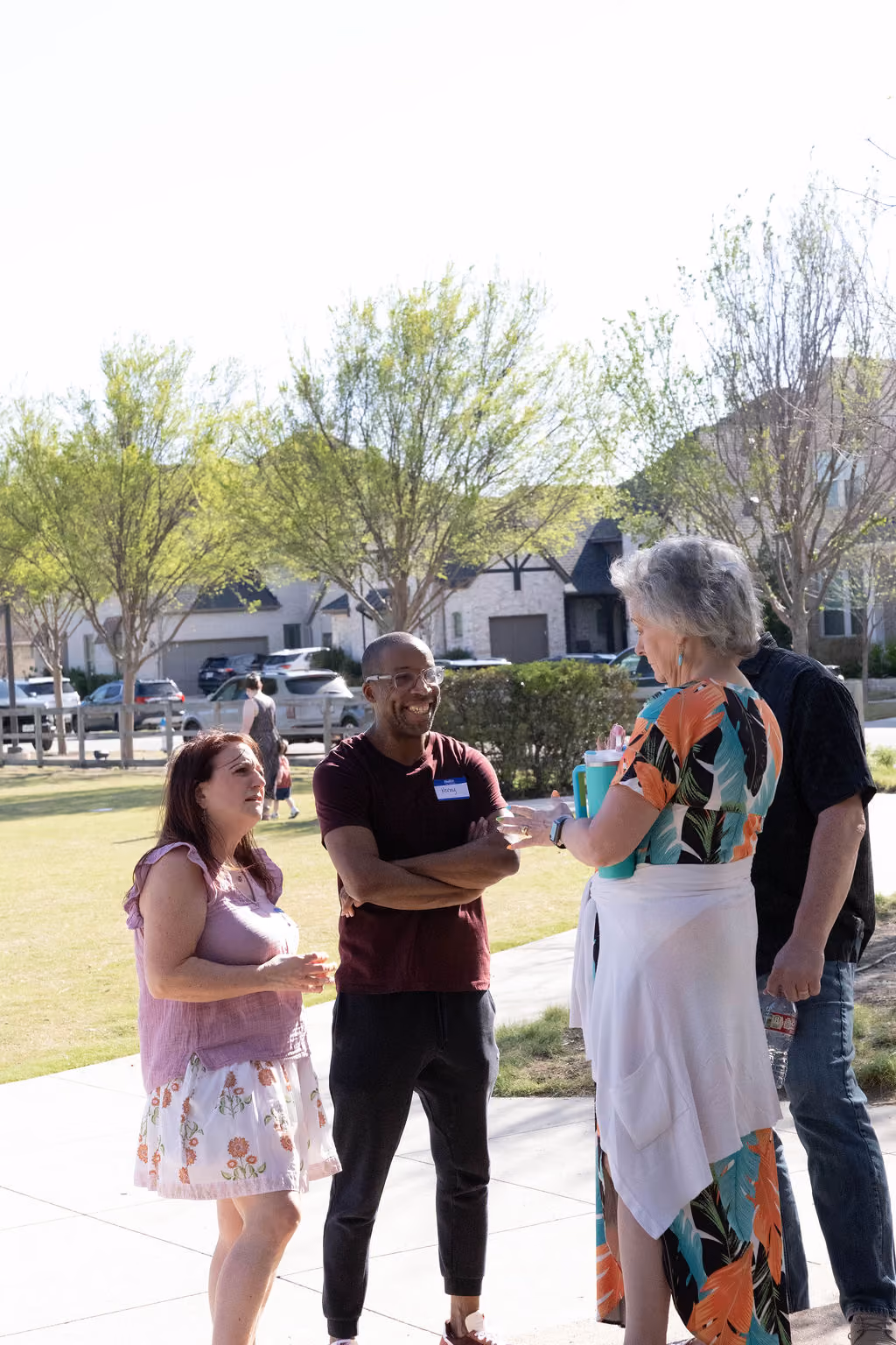 A small group of four adults talking together outdoors