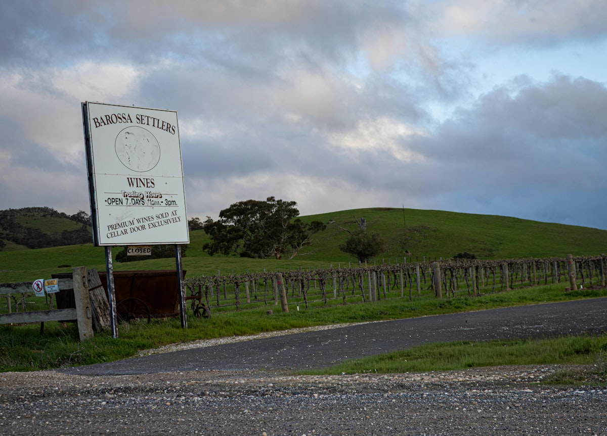 Winery entrance with vineyard and rolling hills