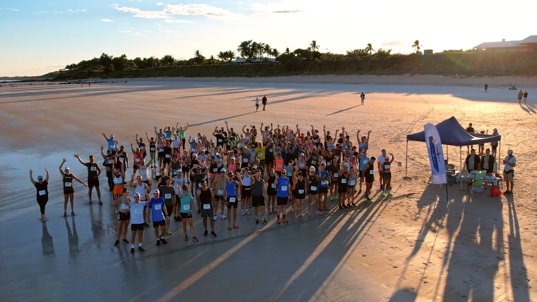 Runners on Cable Beach at the Broome International Airport Marathon