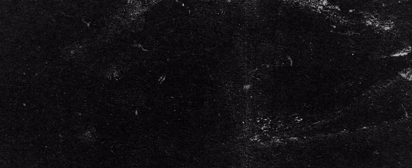 Dark textured black surface with subtle white scratches and scuffs throughout. (unsplash)