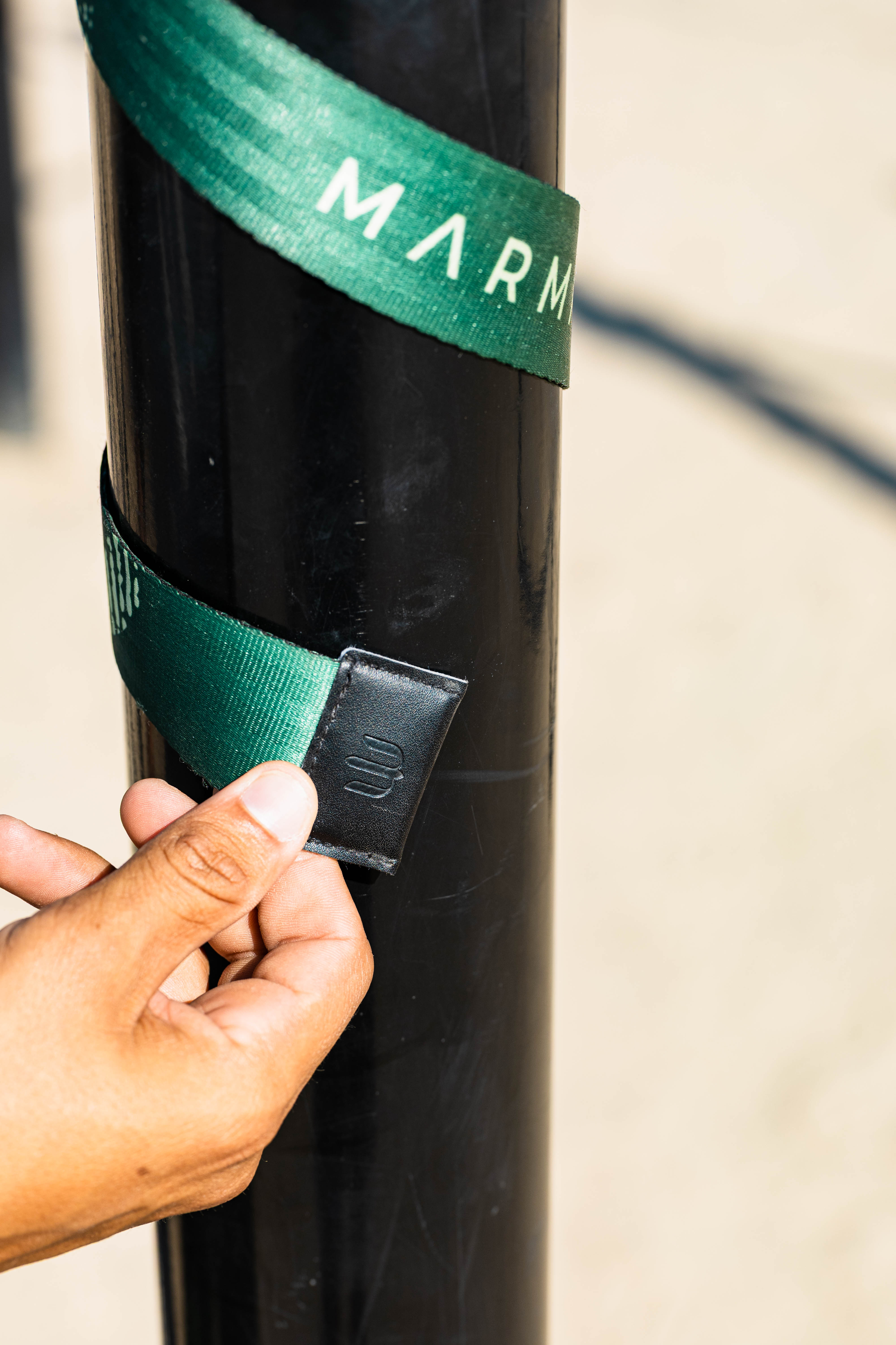 Magnetic strap tip snapping into the leather patch, keeping strap ends secured and tidy