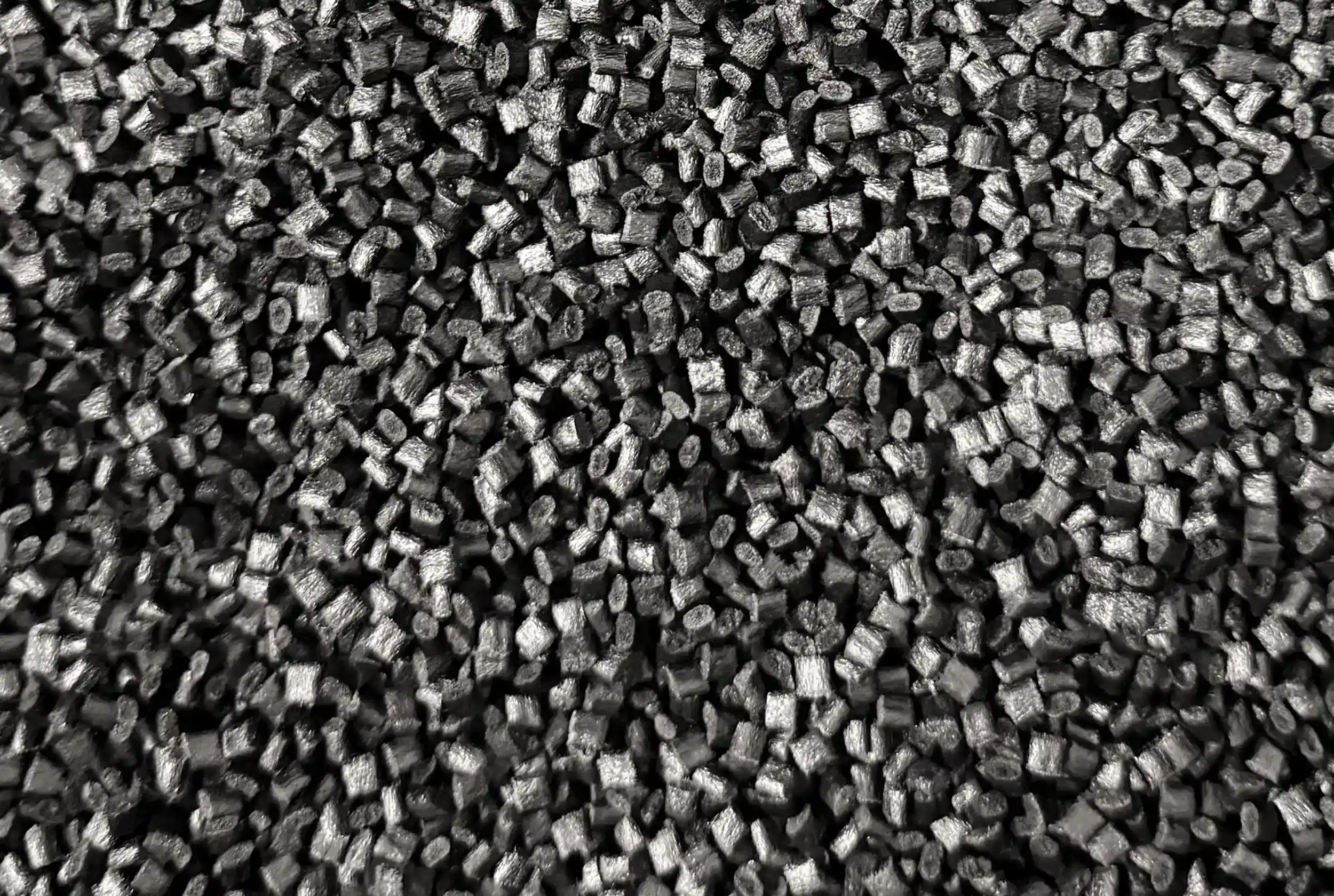 Close-up of black HDPro granulate, the thermoplastic used to 3D print the hulls