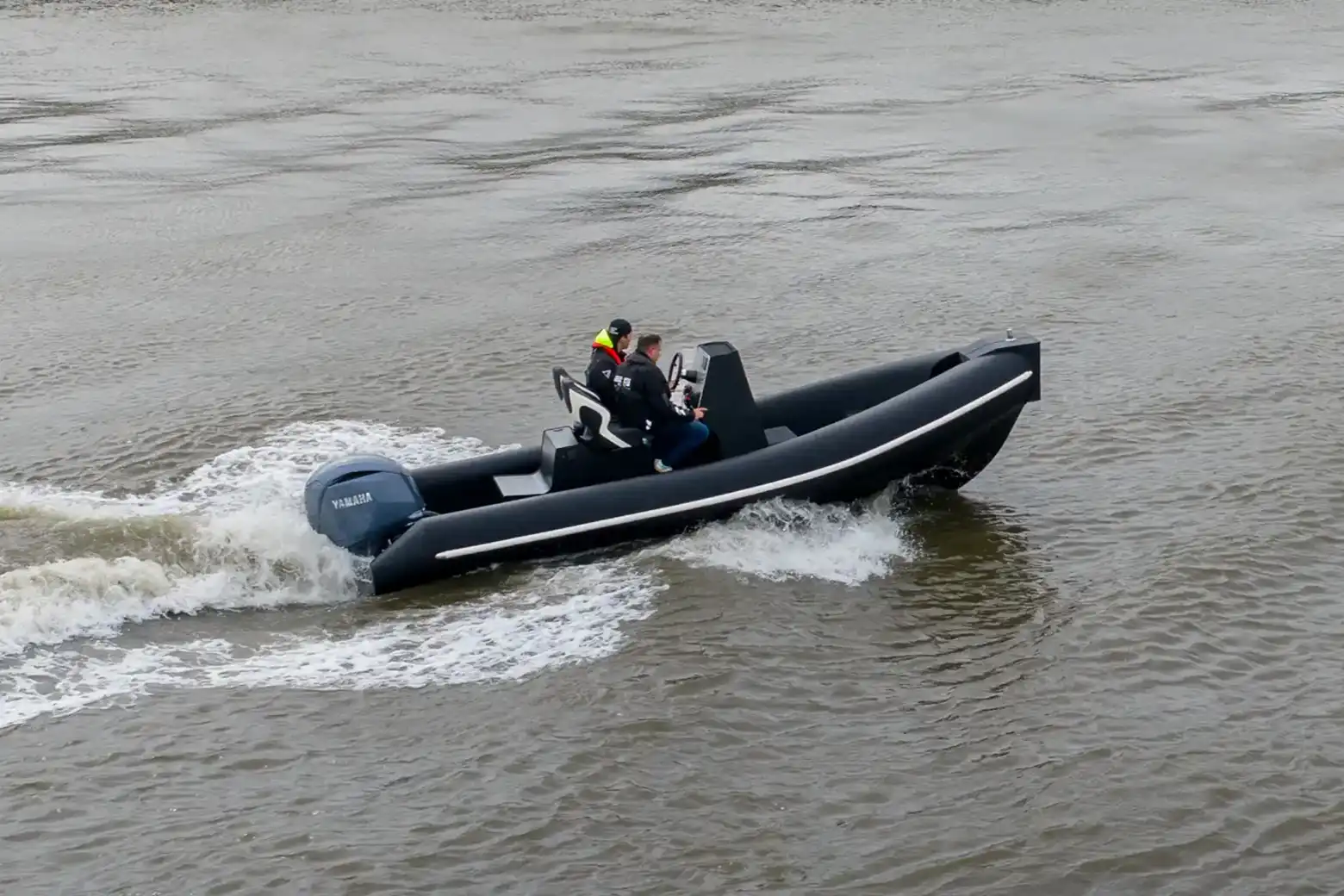6M RIB running at speed on open water in front of a sea wall