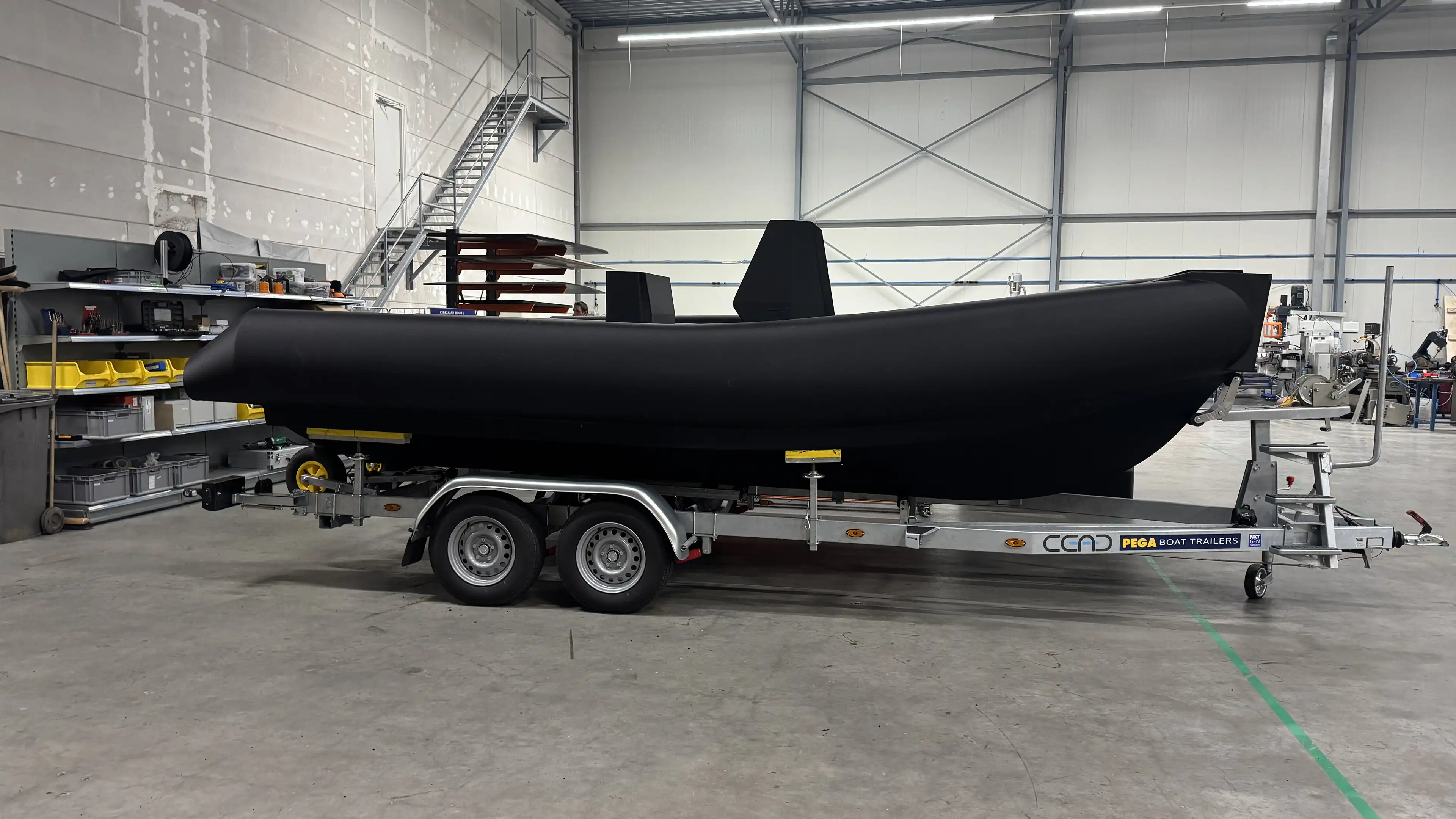 6M RIB on a trailer in the workshop, side view of the printed hull and tubes