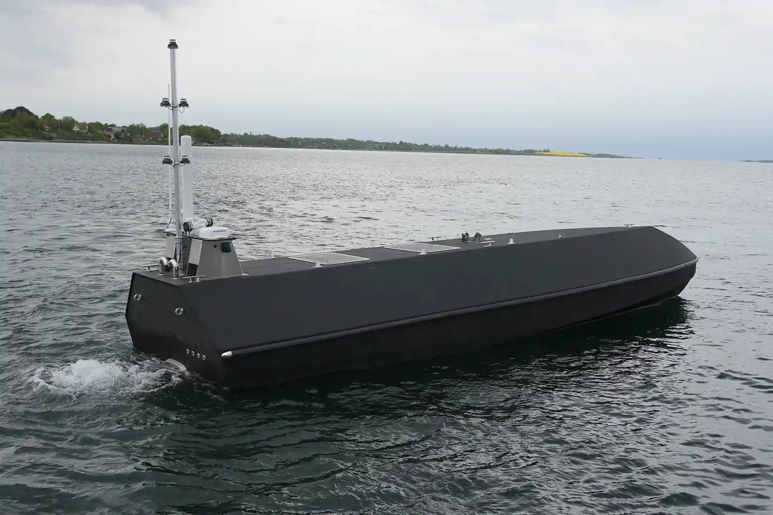 Unmanned surface vessel with a 3D printed hull underway on open water