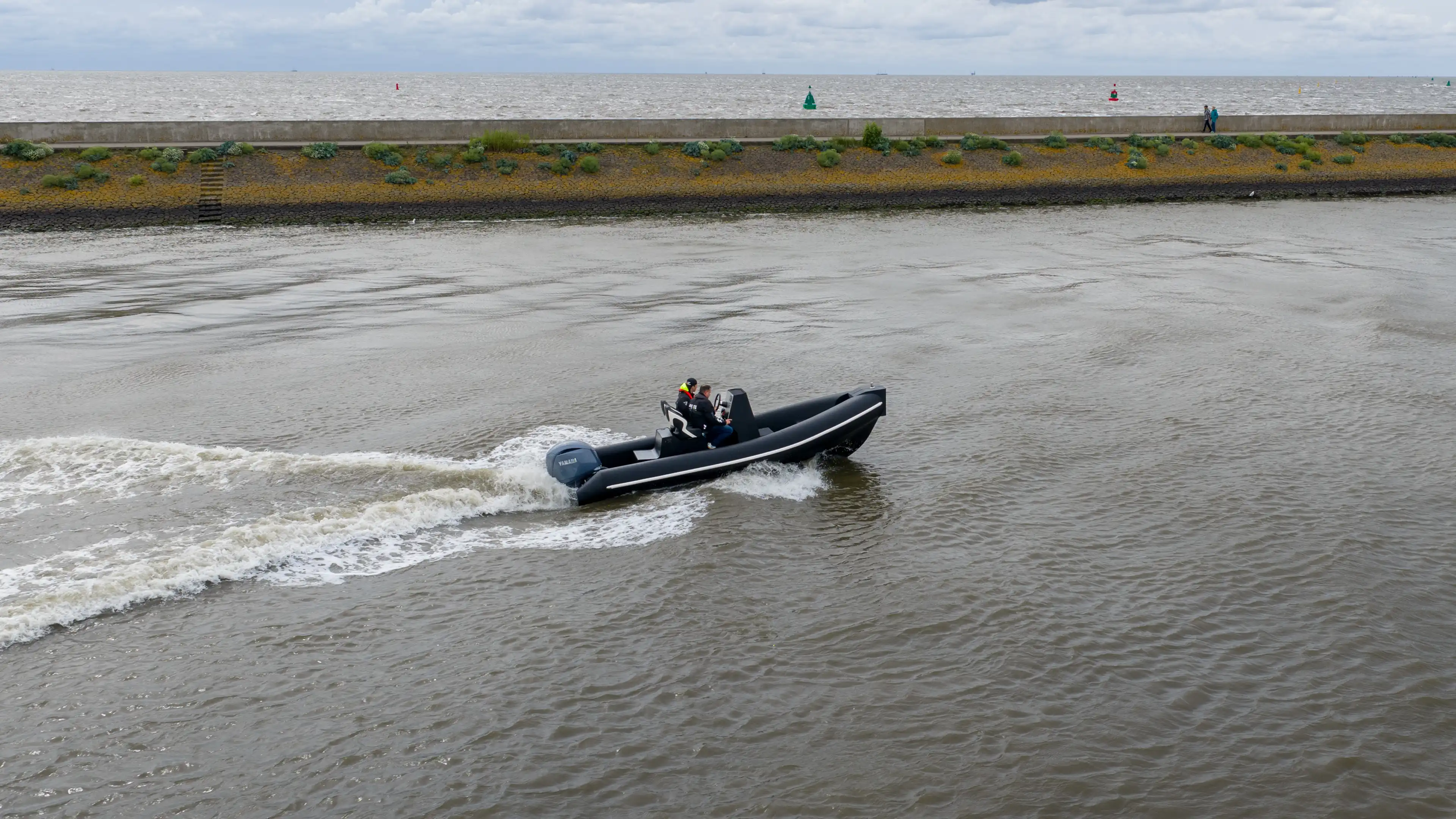 6M RIB running at speed on open water in front of a sea wall