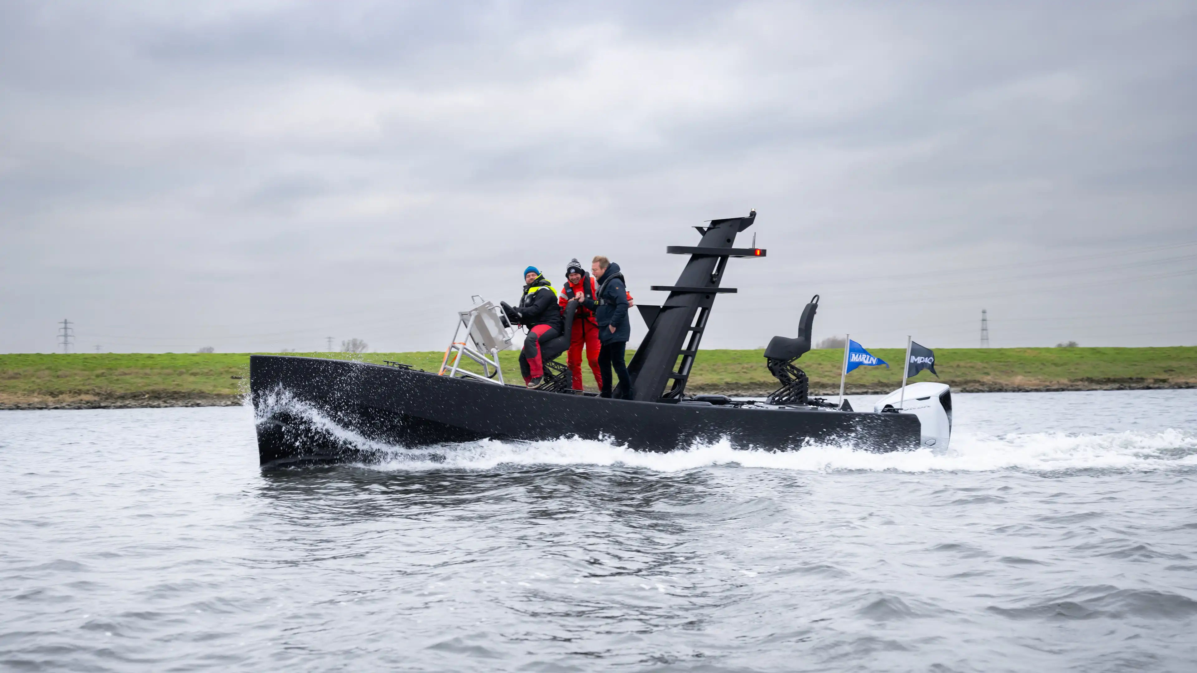 Crew on board a 3D printed workboat during a trial on inland water