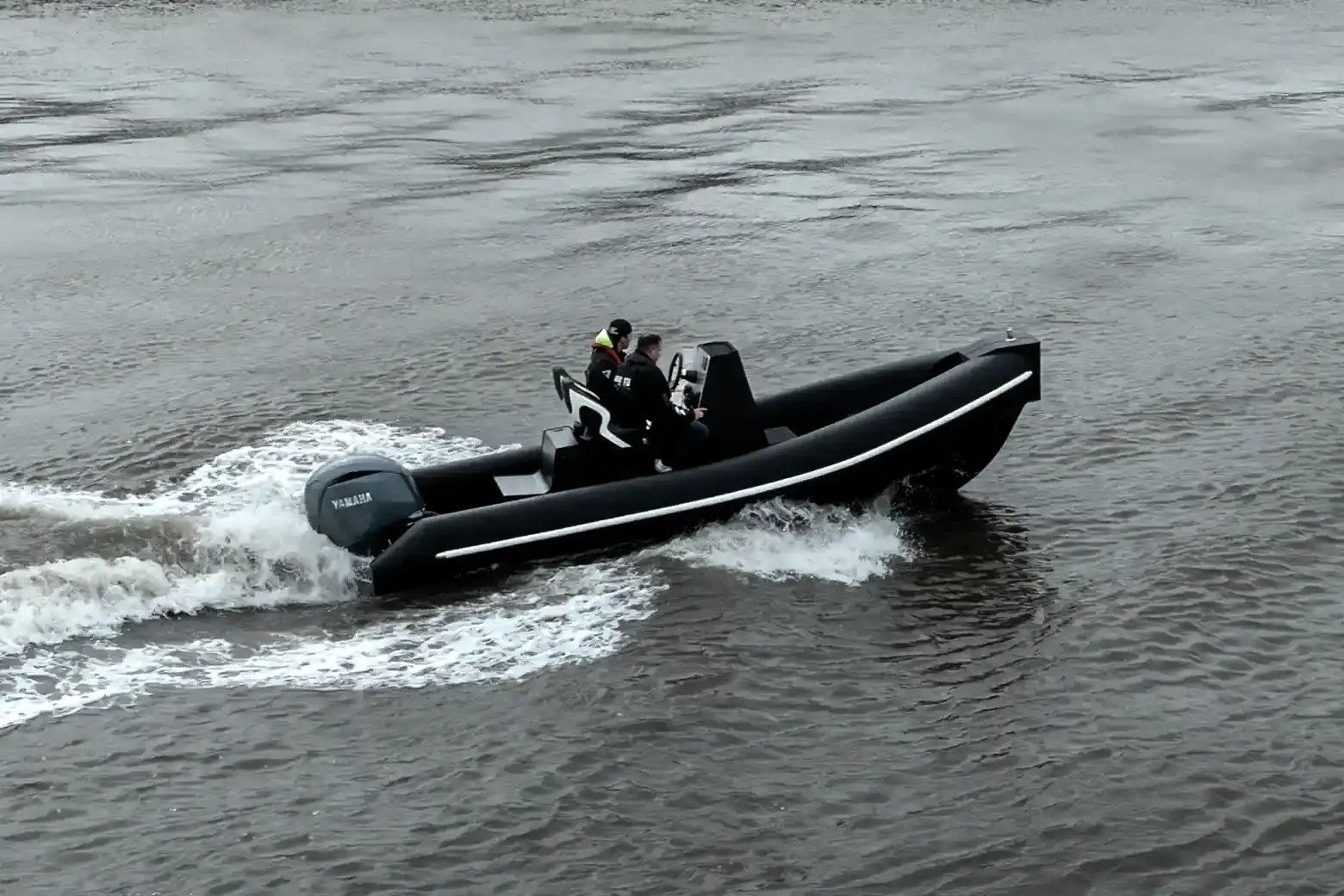 6M RIB running at speed on open water in front of a sea wall