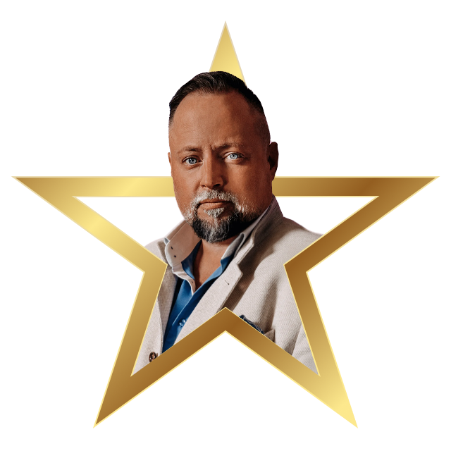 Man with short hair and beard wearing a beige blazer and blue shirt inside a gold star frame.