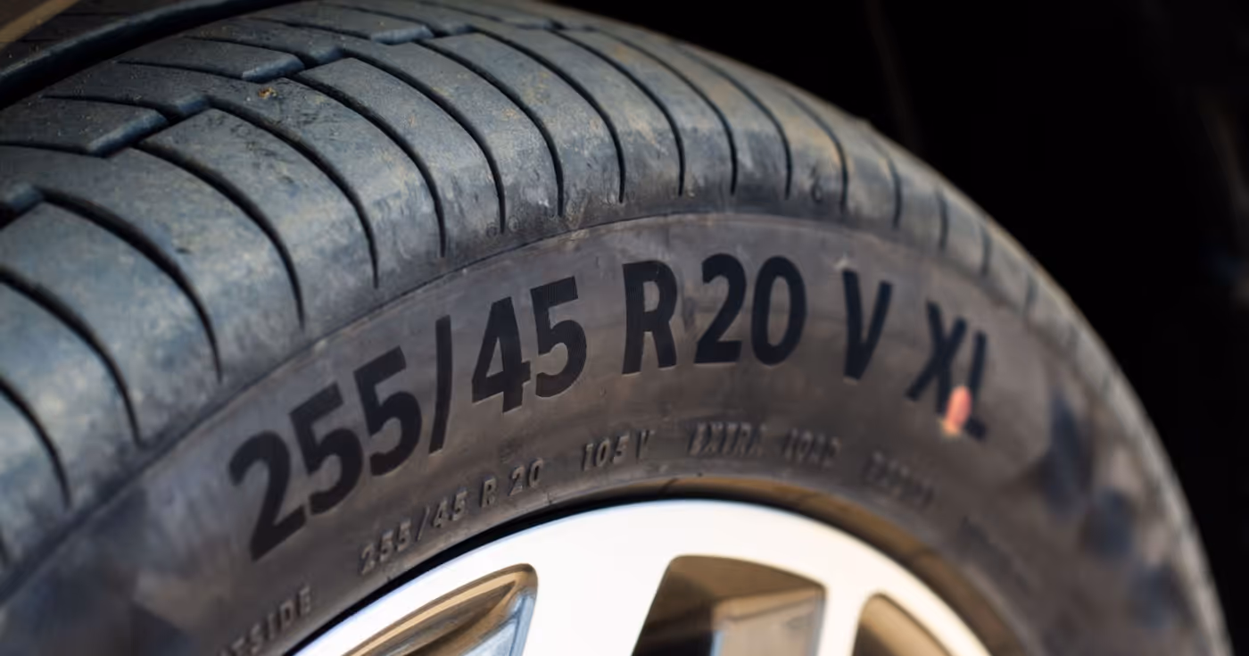 Close-up of a car tire showing size markings 255/45 R20 V XL on the sidewall.