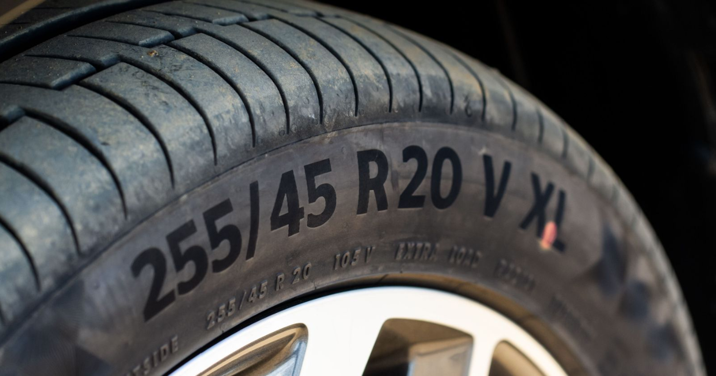 Close-up of a car tire showing size markings 255/45 R20 V XL on the sidewall.