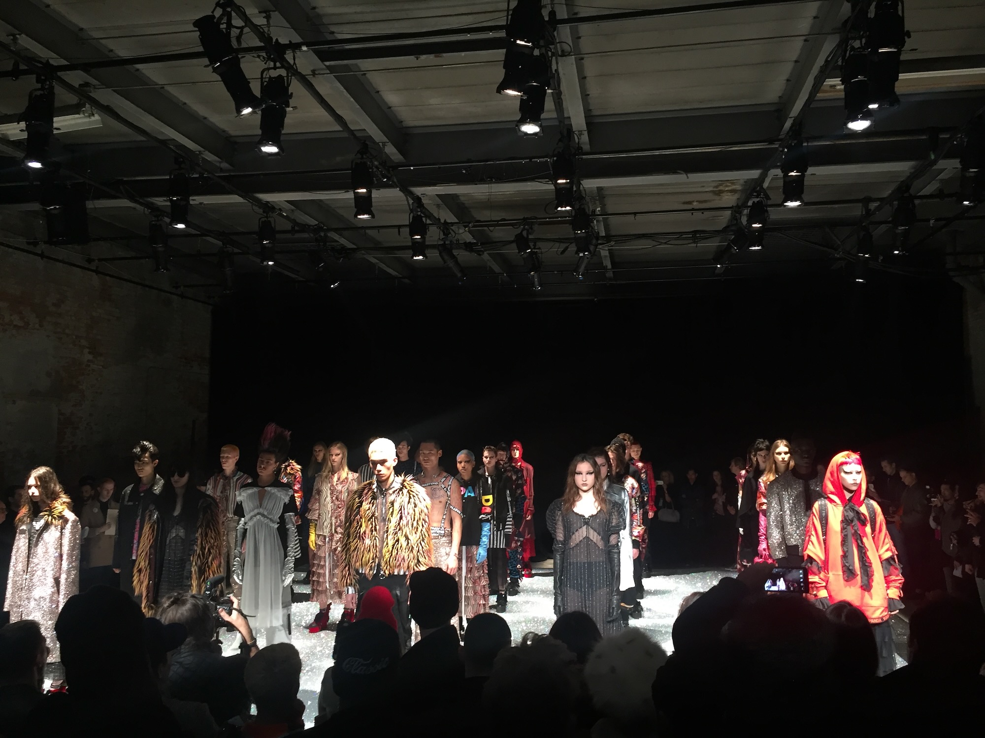 Fashion runway show with dramatic stage lighting