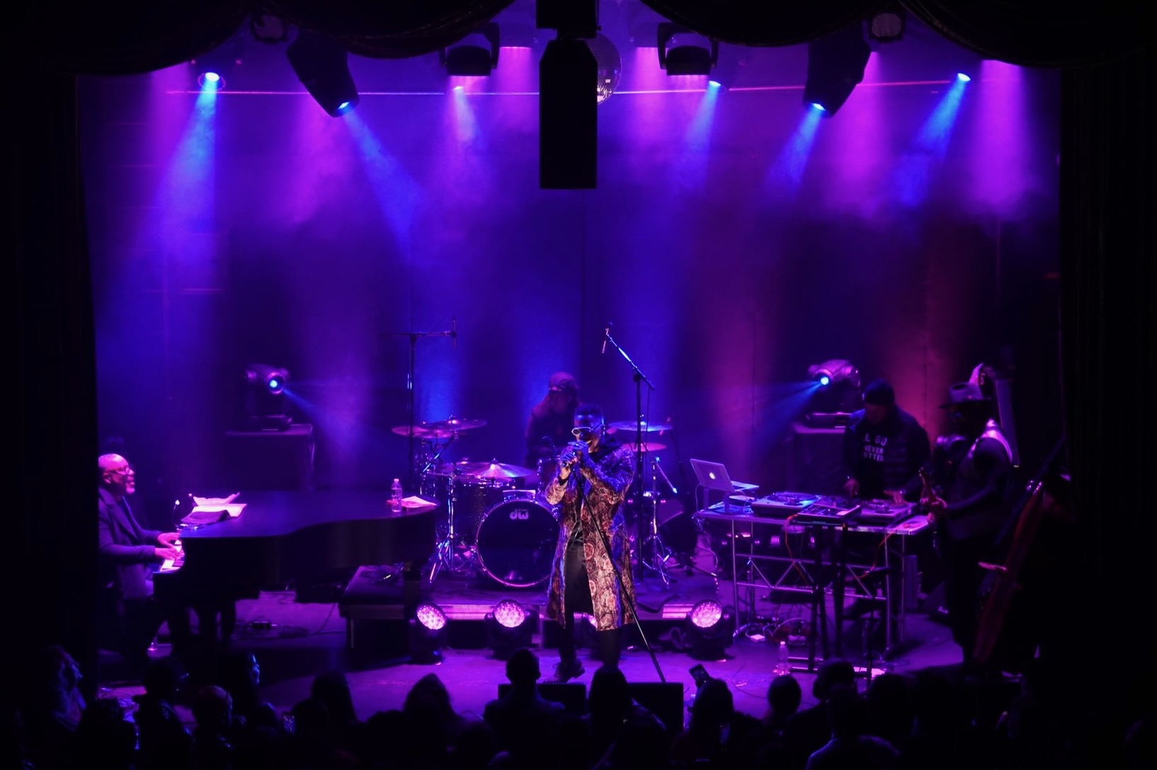 Live concert performance with dramatic stage lighting