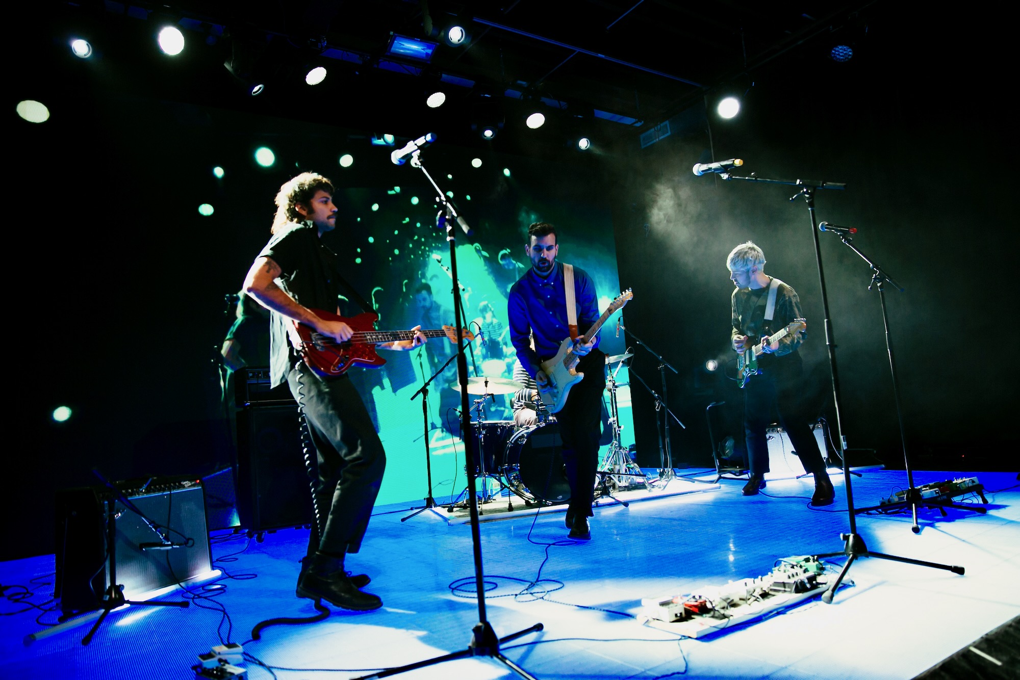 Live band performing on stage under concert lighting