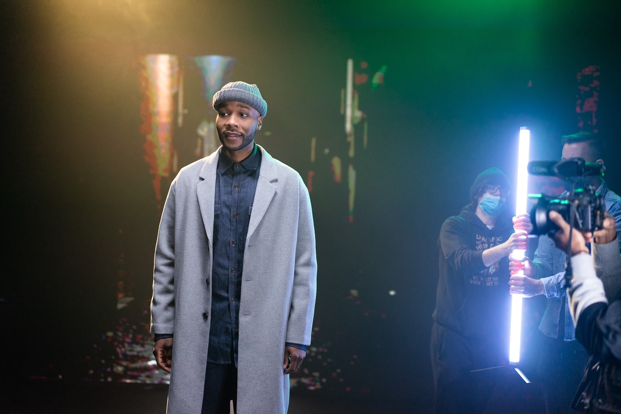 Performer lit by colorful concert stage lighting
