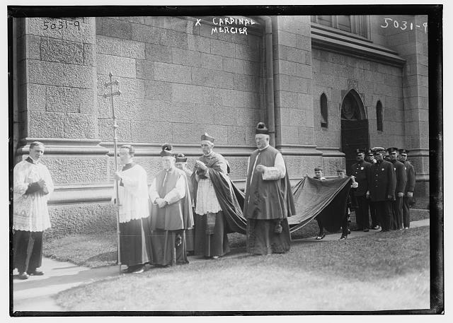 Black-and-white photograph of Cardinal Mercier and clergy in procession outside a building in the USA in 1919.