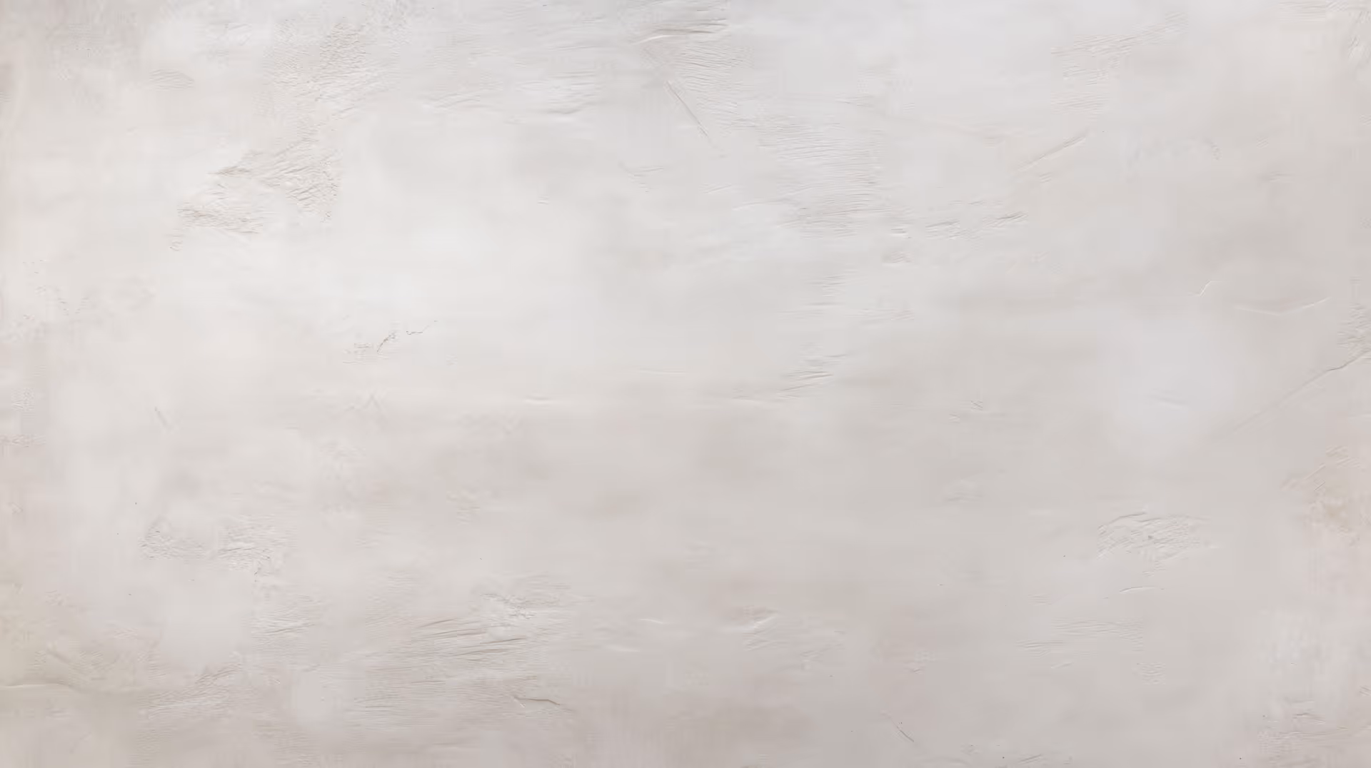 Light beige textured concrete wall background with subtle irregular patterns.