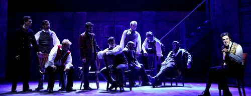 Marius stands apart in a pool of light as the students appear around him in “Empty Chairs at Empty Tables” from Les Misérables.