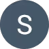 Circle with dark gray background and white letter S in the center.