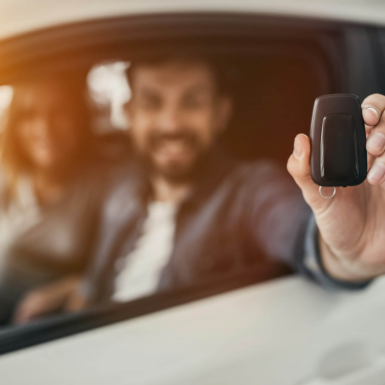 Photo of happy man who is holding his car keys to his new car that he's been able to purchase as Jacko Finance was able to get him vehicle finance.