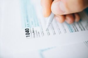 Hand completing IRS Form 1040
