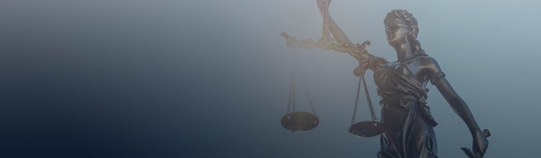 Lady Justice statue against a blue background