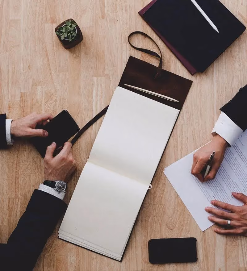Client signing legal documents with an attorney